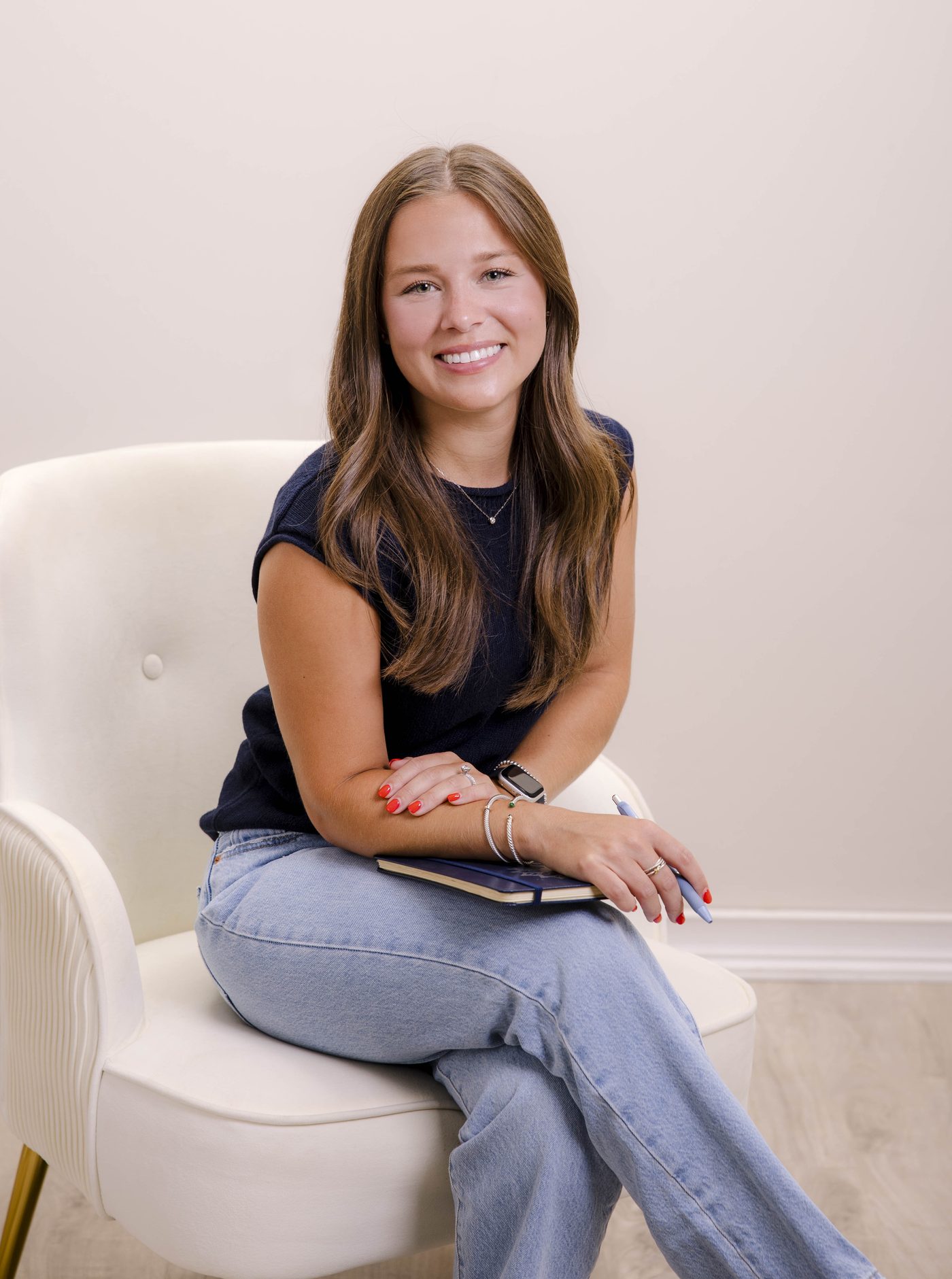 Alexa DiMeglio, Licensed Clinical Social Worker, smiling and seated in a chair